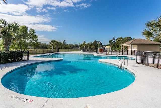 view of swimming pool with a patio