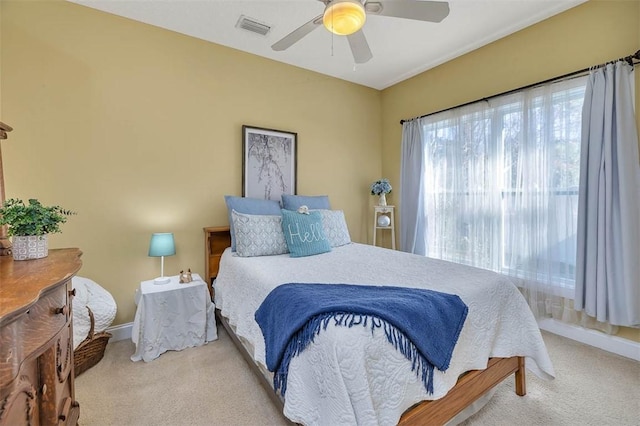 bedroom featuring ceiling fan and light carpet