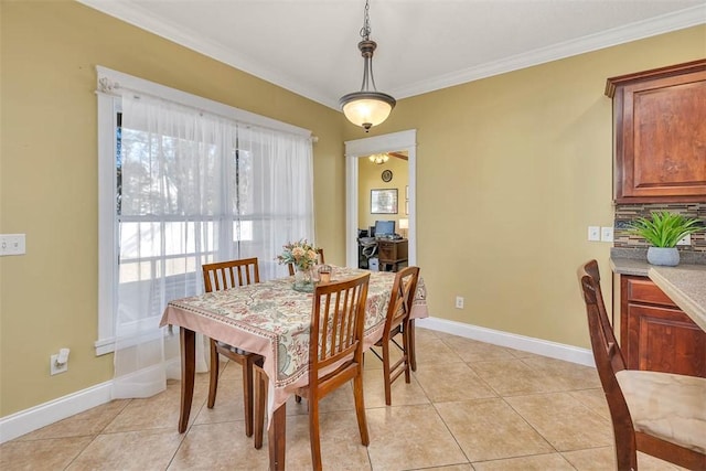 dining space with light tile patterned flooring and crown molding