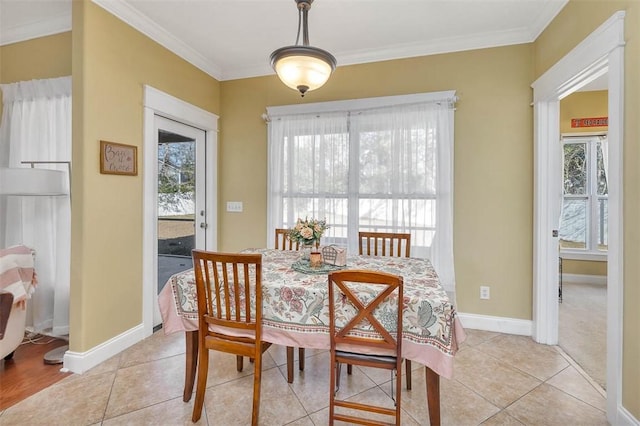 dining area featuring crown molding and light tile patterned flooring