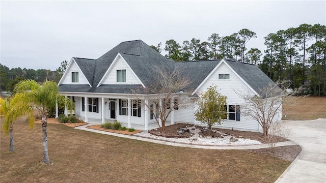 view of front of house with covered porch and a front yard