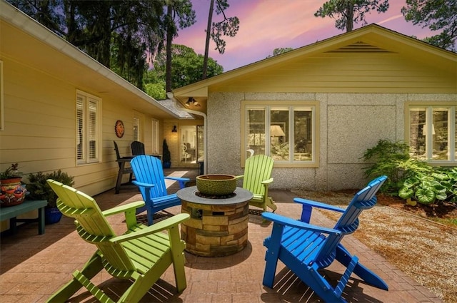 552 Old Plantation Rd, Jekyll Island, GA 31527 - patio terrace at dusk with an outdoor fire pit and a patio