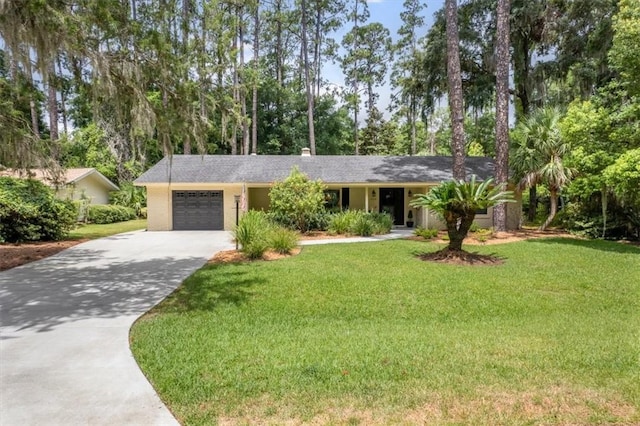 552 Old Plantation Rd, Jekyll Island, GA 31527 - ranch-style home with concrete driveway, an attached garage, a front yard, and view of scattered trees