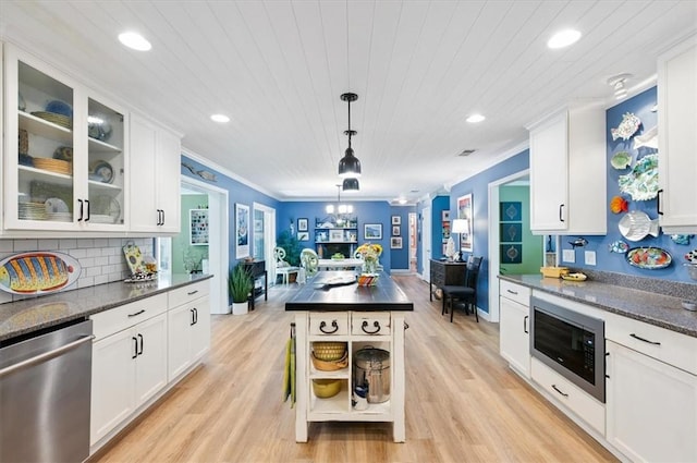 552 Old Plantation Rd, Jekyll Island, GA 31527 - kitchen with appliances with stainless steel finishes, recessed lighting, white cabinets, glass insert cabinets, and light wood-style floors