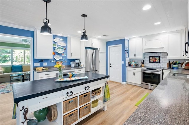 552 Old Plantation Rd, Jekyll Island, GA 31527 - kitchen featuring appliances with stainless steel finishes, custom exhaust hood, white cabinetry, light wood-style flooring, and pendant lighting