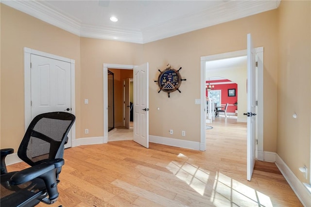 office with crown molding and light hardwood / wood-style floors