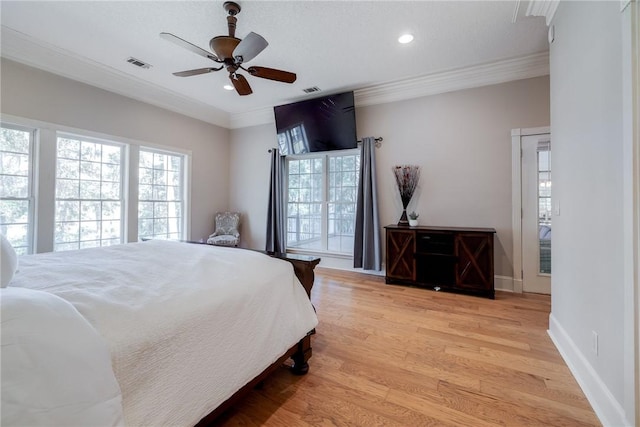 bedroom featuring multiple windows, crown molding, ceiling fan, and light hardwood / wood-style flooring