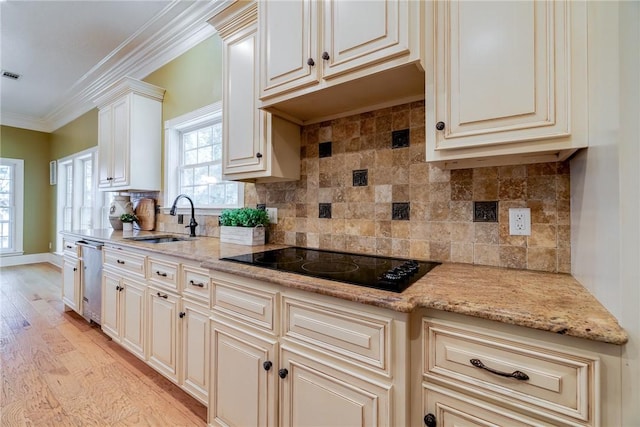 kitchen featuring black electric cooktop, ornamental molding, light stone countertops, and sink