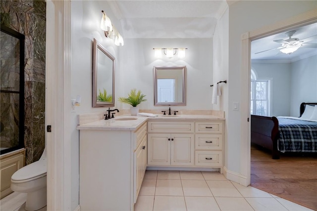 bathroom featuring toilet, ornamental molding, vanity, ceiling fan, and tile patterned flooring