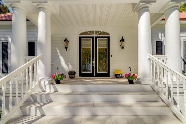 view of exterior entry with covered porch