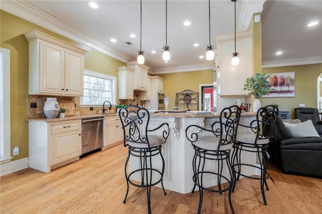 kitchen featuring decorative light fixtures, a kitchen breakfast bar, light stone counters, kitchen peninsula, and stainless steel appliances