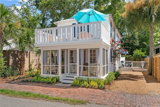 405 Everett St, Saint Simons Island, GA 31522 - view of front of home featuring a balcony and a sunroom
