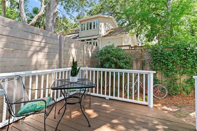 405 Everett St, Saint Simons Island, GA 31522 - wooden terrace featuring a fenced backyard and outdoor dining space