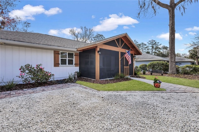 246 Alabama St, Saint Simons Island, GA 31522 - view of front of home featuring a sunroom, a front yard, and a shingled roof