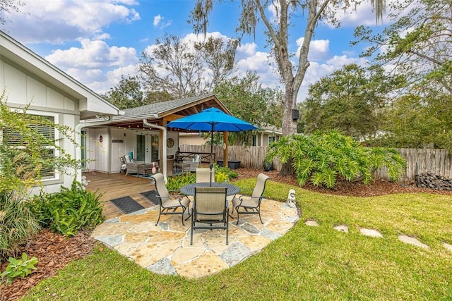 246 Alabama St, Saint Simons Island, GA 31522 - view of yard featuring a deck, outdoor dining area, and a patio area