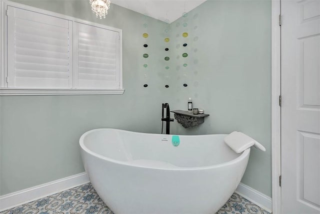 246 Alabama St, Saint Simons Island, GA 31522 - bathroom featuring baseboards, a freestanding bath, and tile patterned floors