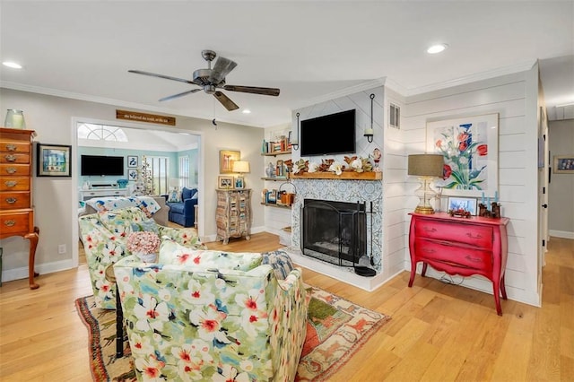 246 Alabama St, Saint Simons Island, GA 31522 - living area featuring crown molding, a ceiling fan, wood finished floors, baseboards, and a fireplace with raised hearth