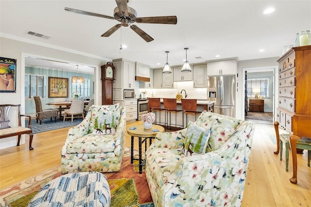 246 Alabama St, Saint Simons Island, GA 31522 - living area featuring plenty of natural light, ornamental molding, light wood-style floors, recessed lighting, and a ceiling fan