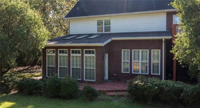 back of property featuring a deck