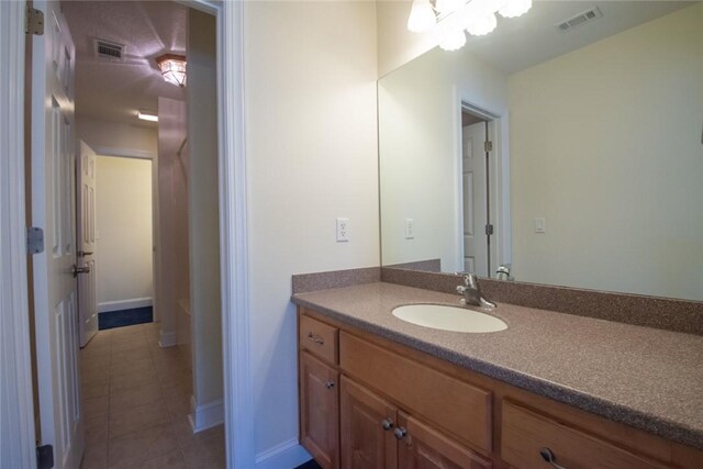 bathroom featuring tile patterned floors, a textured ceiling, and toilet