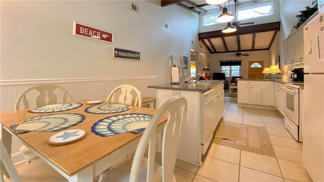kitchen featuring a ceiling fan, visible vents, a sink, light tile patterned floors, and white appliances