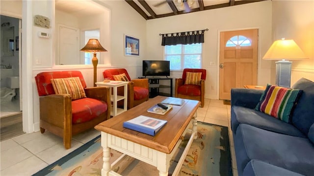 living room with lofted ceiling with beams and light tile patterned floors