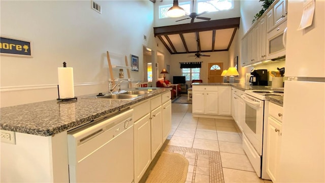 kitchen featuring visible vents, a sink, white appliances, a ceiling fan, and light tile patterned floors