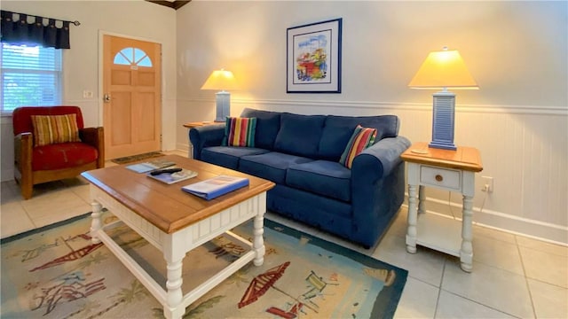 living area featuring baseboards, wainscoting, and light tile patterned floors