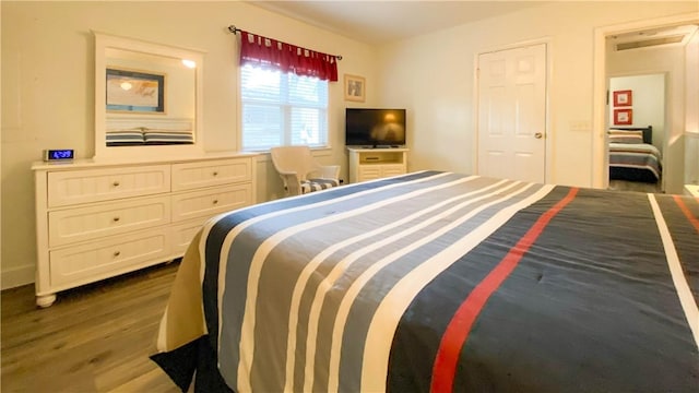 bedroom with dark wood-style flooring