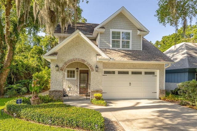 107 Reynoso Ave, Saint Simons Island, GA 31522 - view of front of property featuring driveway, a shingled roof, brick siding, and a porch