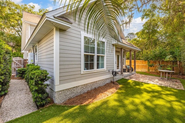 107 Reynoso Ave, Saint Simons Island, GA 31522 - view of home's exterior with a patio and a gate