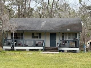 ranch-style house with a front yard and covered porch