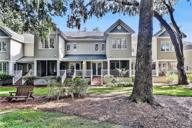 back of property featuring covered porch