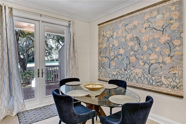 dining space with french doors and crown molding