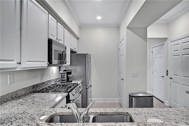 kitchen featuring crown molding, sink, appliances with stainless steel finishes, light stone counters, and white cabinetry