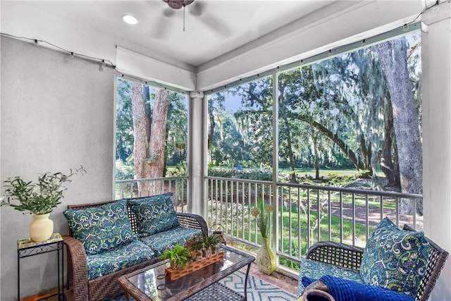 sunroom featuring ceiling fan