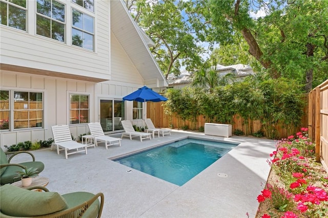 view of pool featuring a fenced backyard, a fenced in pool, and a patio area