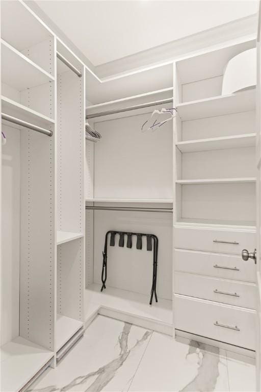 spacious closet featuring marble finish floor