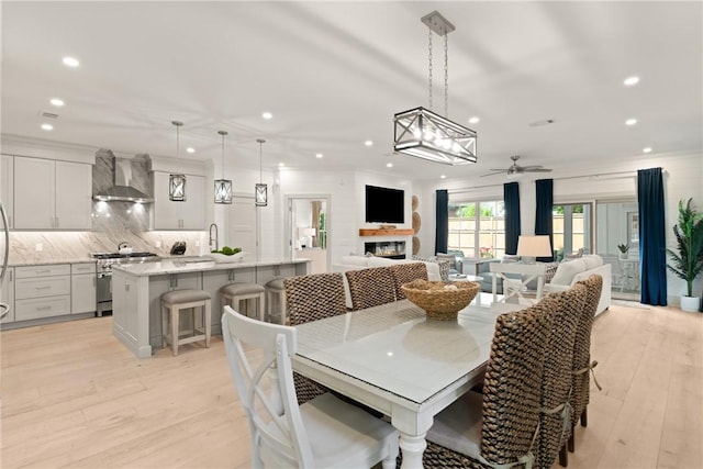 dining space featuring recessed lighting, a ceiling fan, and light wood-style floors