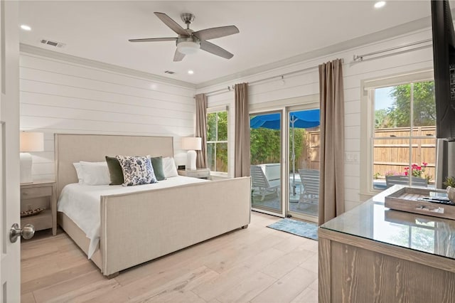 bedroom with light wood-type flooring, visible vents, access to outside, and multiple windows