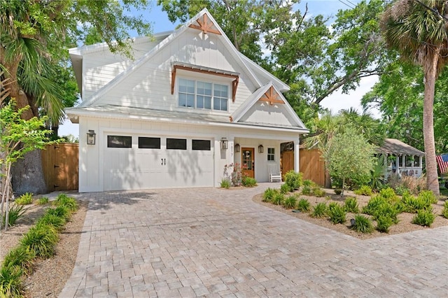 craftsman-style house featuring a garage, decorative driveway, a gate, and fence