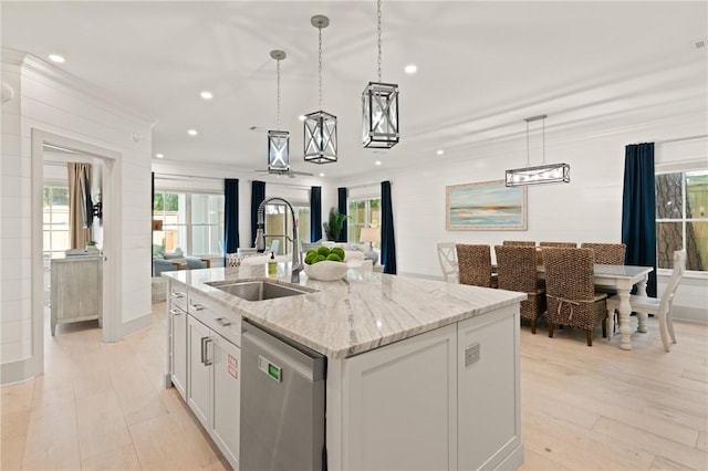 kitchen featuring open floor plan, dishwasher, recessed lighting, and a sink