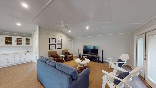 635 Old Plantation Rd, Jekyll Island, GA 31527 - living room with a ceiling fan, light wood-style floors, a decorative wall, and vaulted ceiling