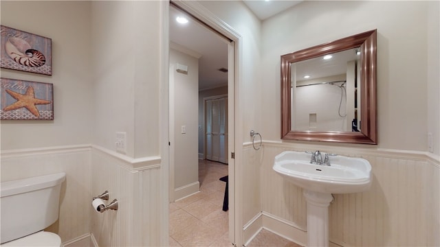 635 Old Plantation Rd, Jekyll Island, GA 31527 - bathroom featuring toilet, a decorative wall, a wainscoted wall, and tile patterned floors