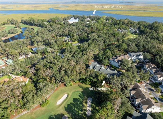 aerial view featuring a water view, view of golf course, and a residential view