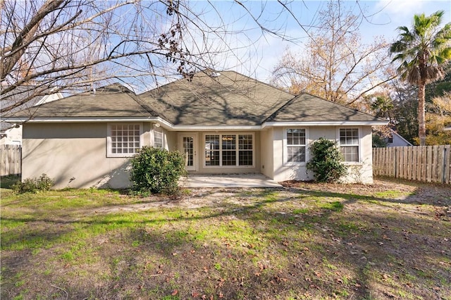 rear view of house with a lawn