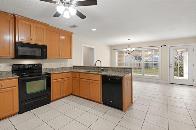 kitchen with black appliances, ceiling fan with notable chandelier, sink, light stone countertops, and kitchen peninsula