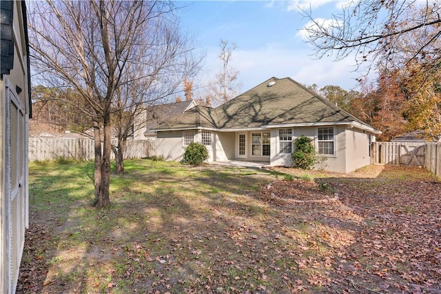 rear view of house with a lawn