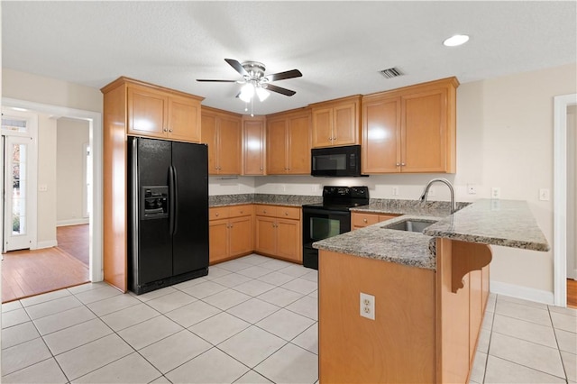 kitchen featuring kitchen peninsula, ceiling fan, sink, black appliances, and light tile patterned flooring