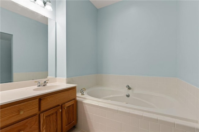 full bath featuring vanity and a garden tub